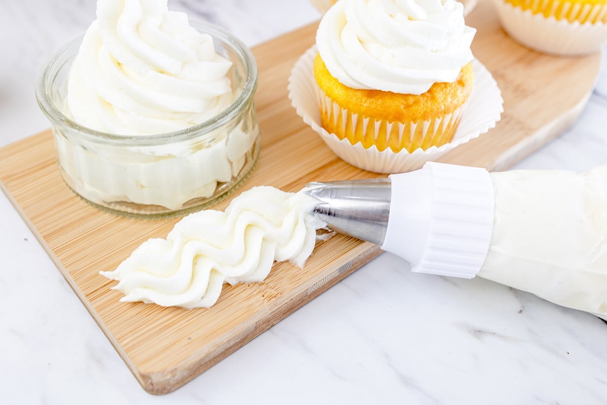 tray with piped vanilla buttercream frosting on it