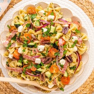 overhead shot of bowl of antipasto pasta salad with wooden spoon