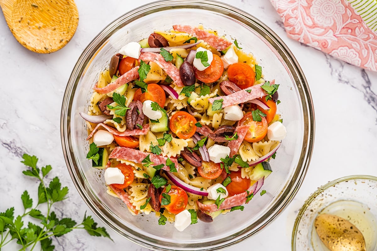 overhead shot of antipasto pasta salad in glass bowl