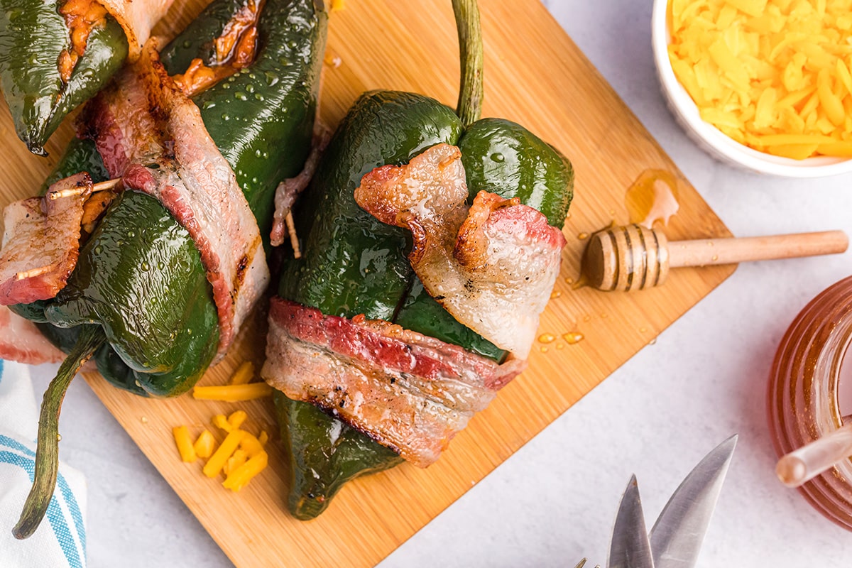 overhead shot of stuffed poblano peppers on a cutting board