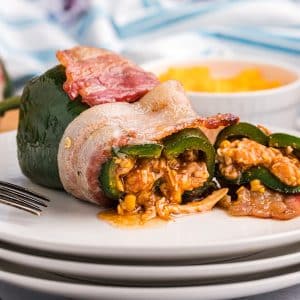 straight on shot of stuffed poblano pepper cut on a plate