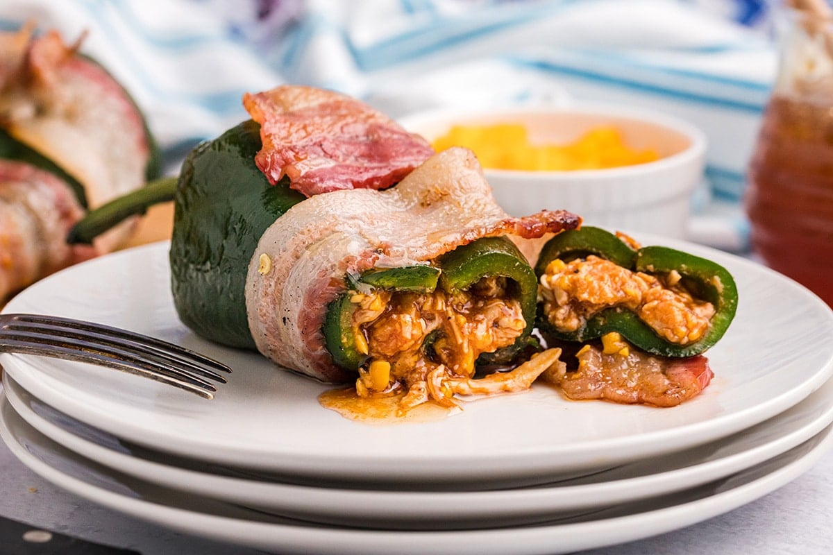 straight on shot of stuffed poblano pepper cut on a plate