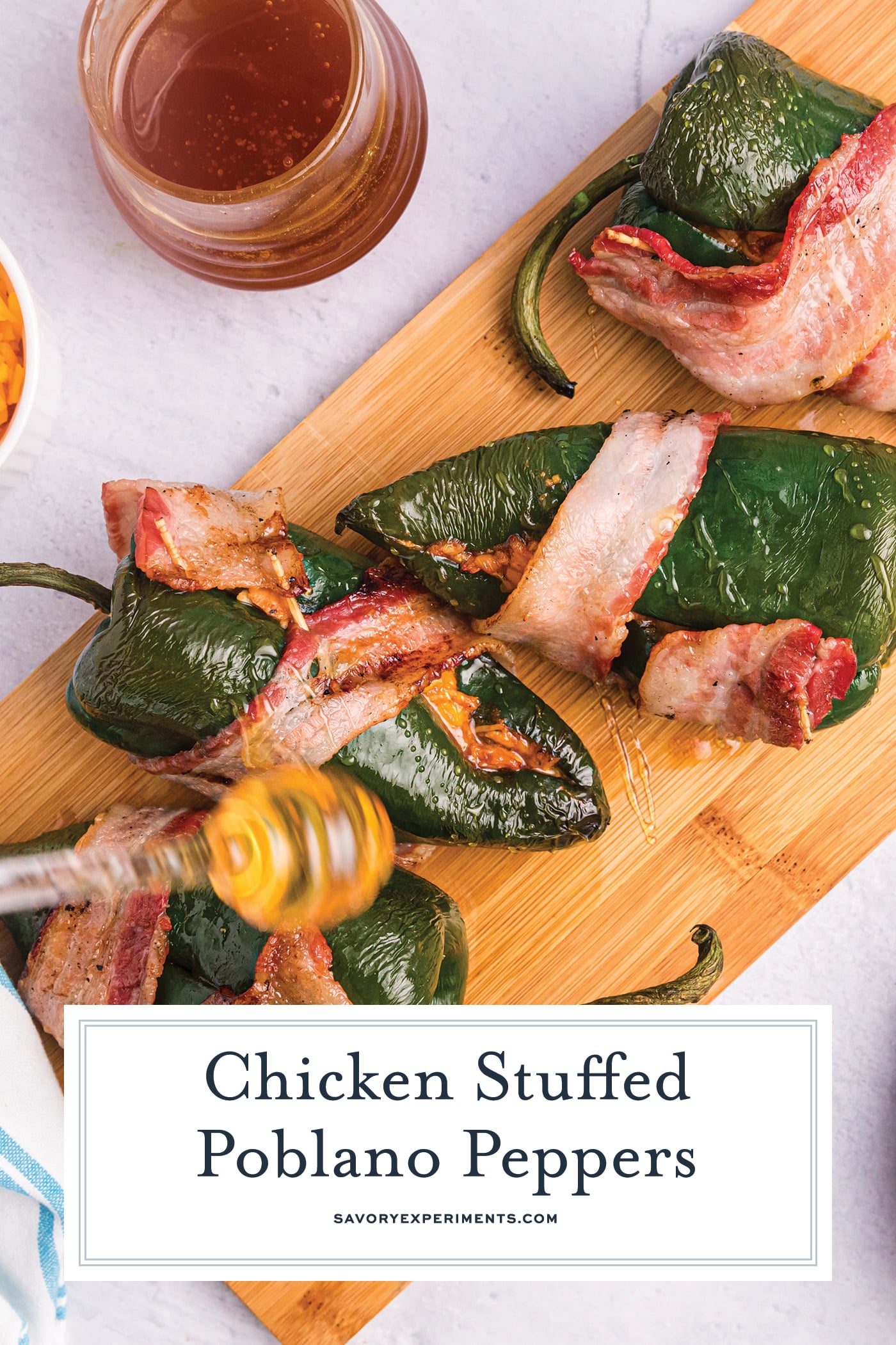 honey drizzling on stuffed poblano peppers with text overlay for pinterest