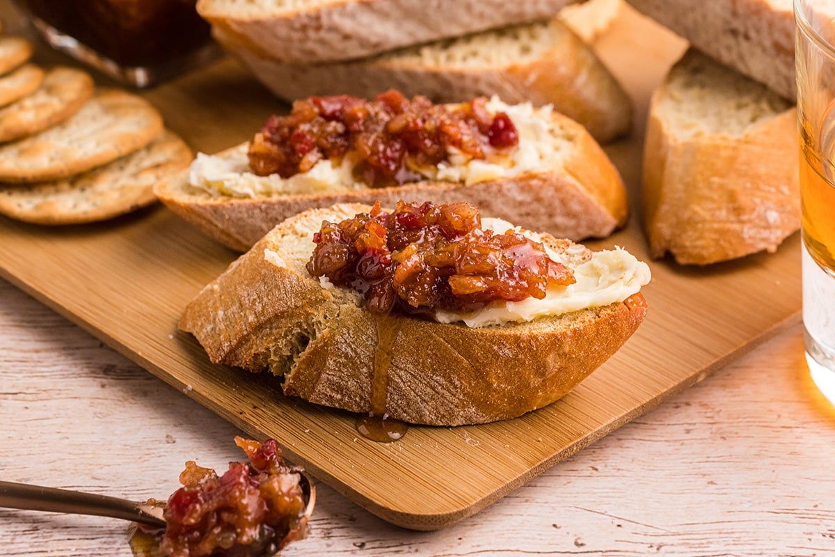 angled shot of bacon jam on bread slices with cheese