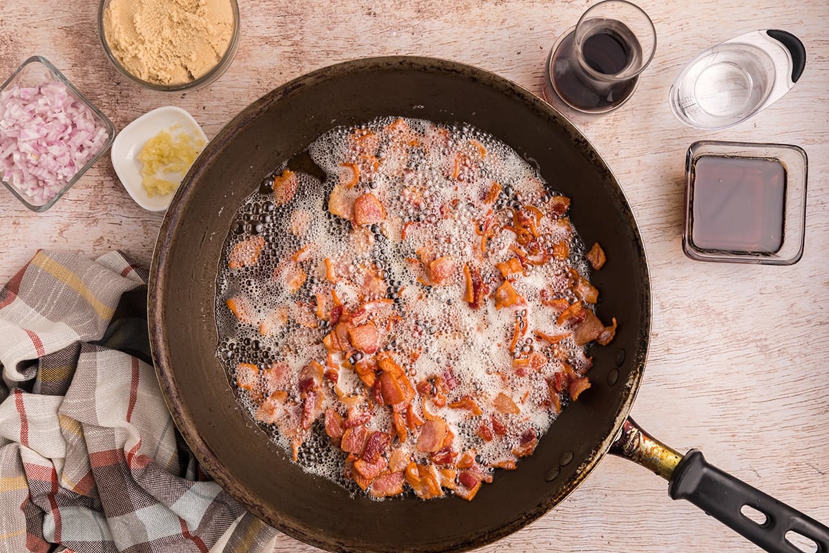 bacon pieces cooking in pan