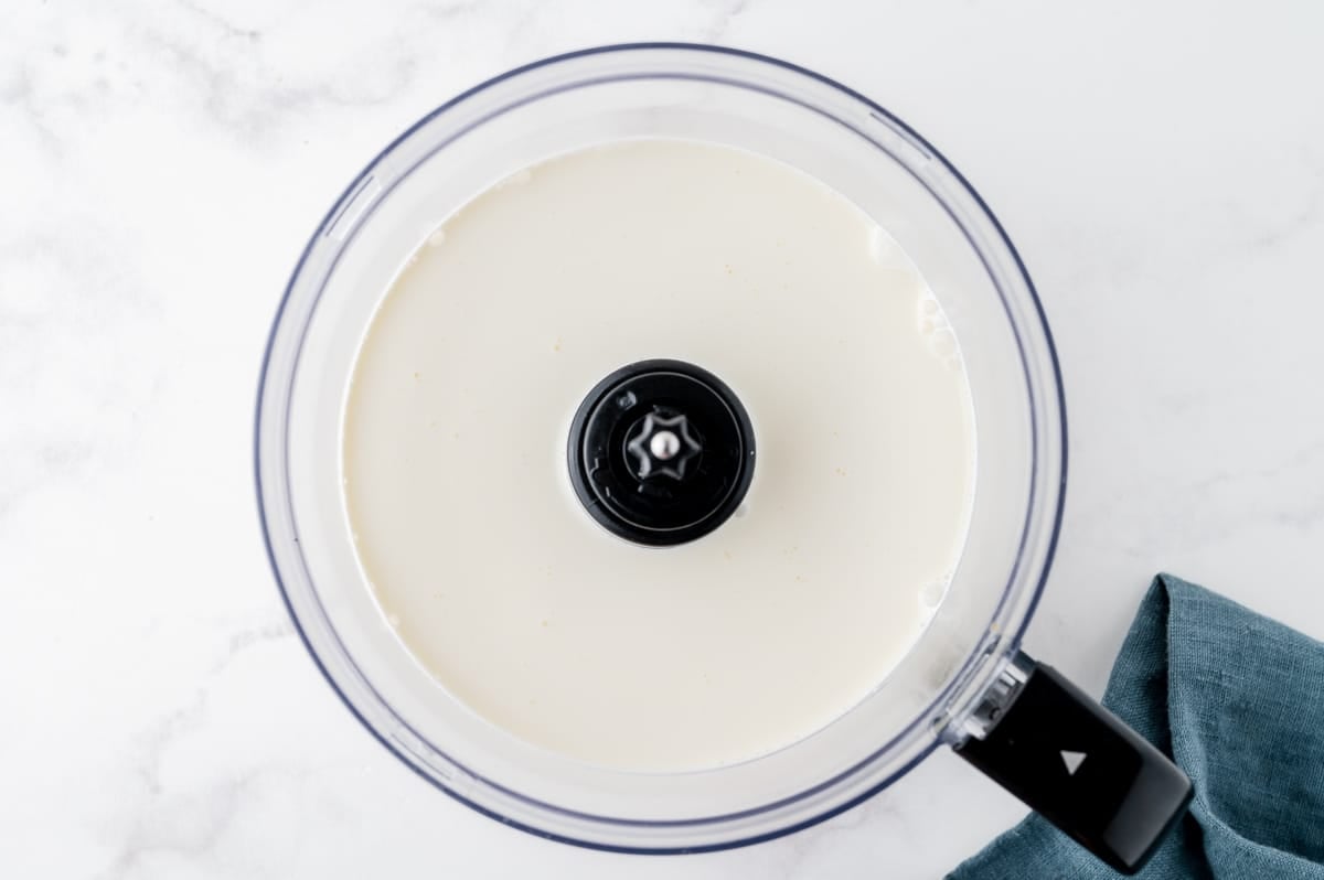 overhead shot of heavy cream in food processor