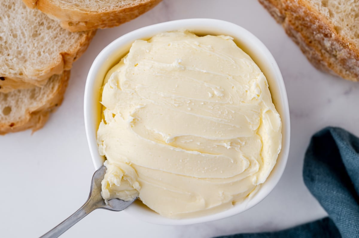 overhead shot of knife in bowl of homemade butter