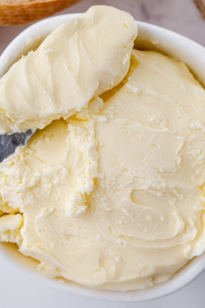 spreading knife in bowl of butter