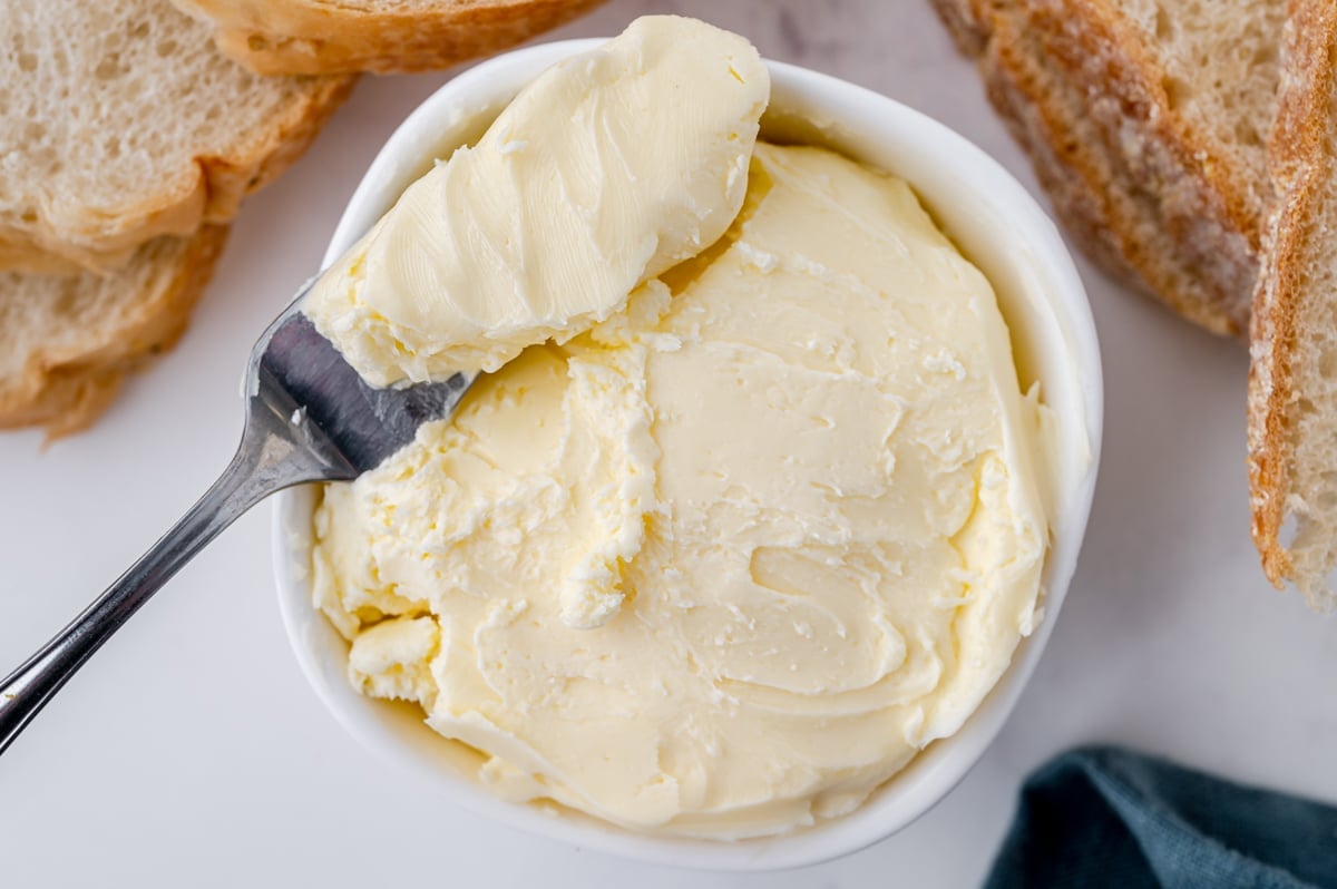 spreading knife in bowl of butter