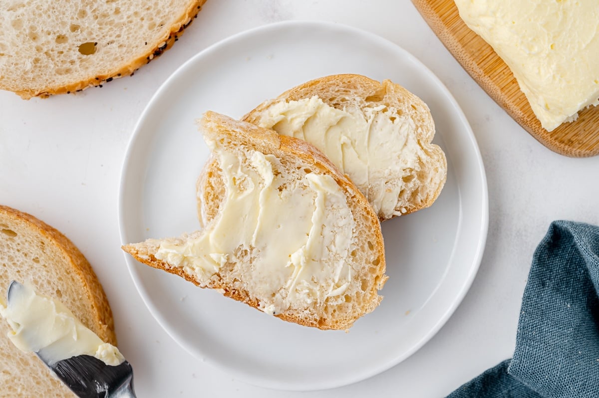 bite taken out of slice of bread with homemade butter