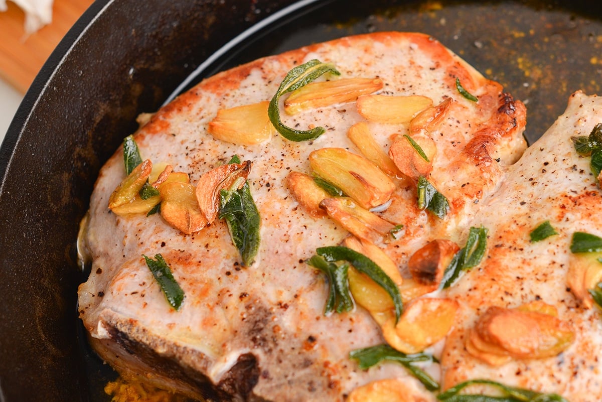 close up of browned garlic on pork chops