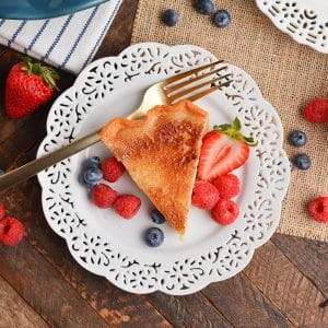 overhead shot of slice of pie on plate with berries