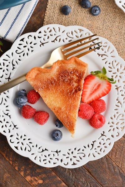 overhead shot of slice of pie on plate with berries
