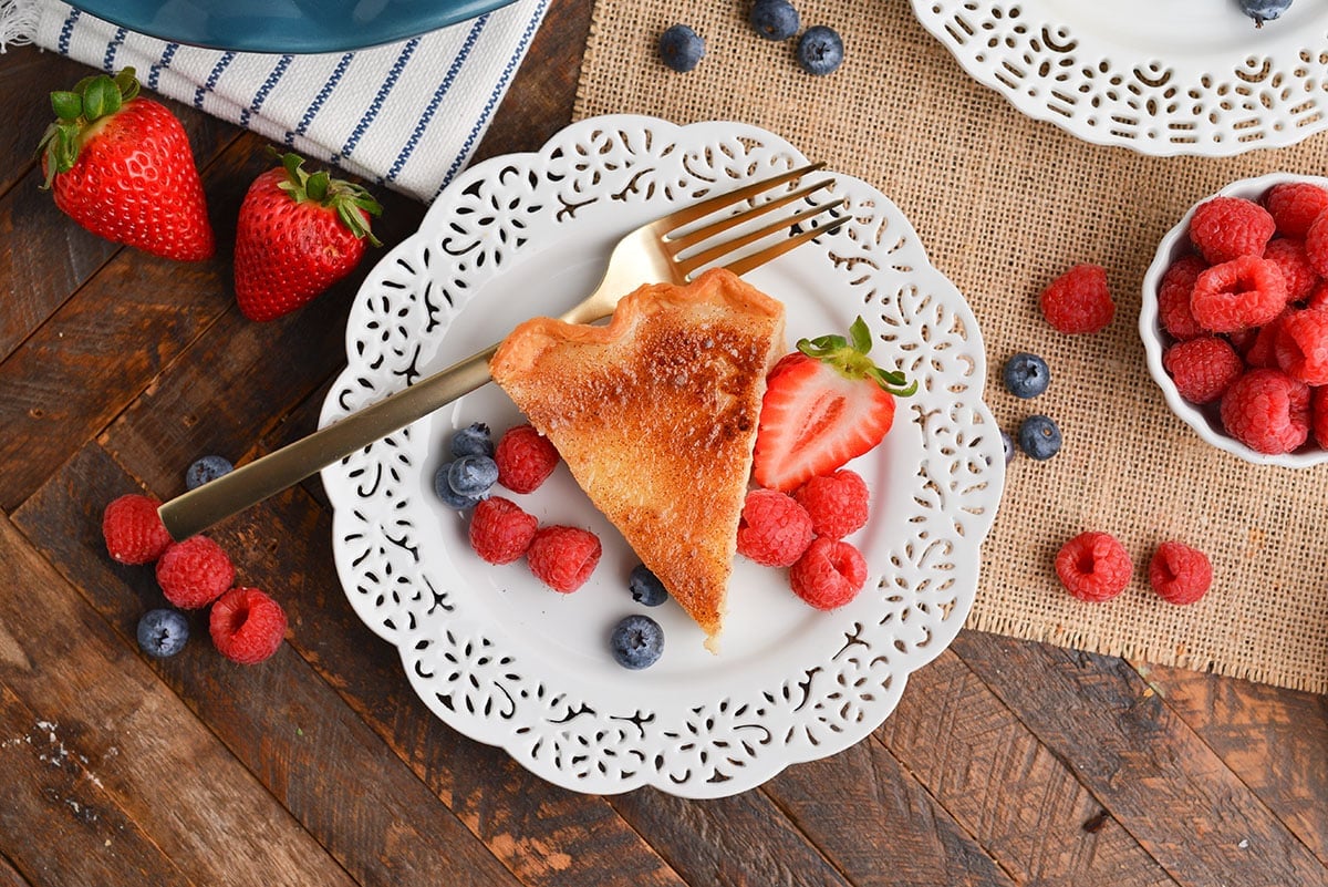 overhead shot of slice of pie on plate with berries