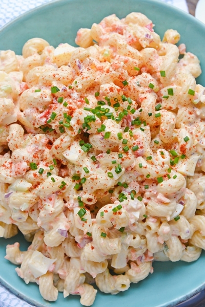 overhead of deviled egg pasta salad with chives and paprika