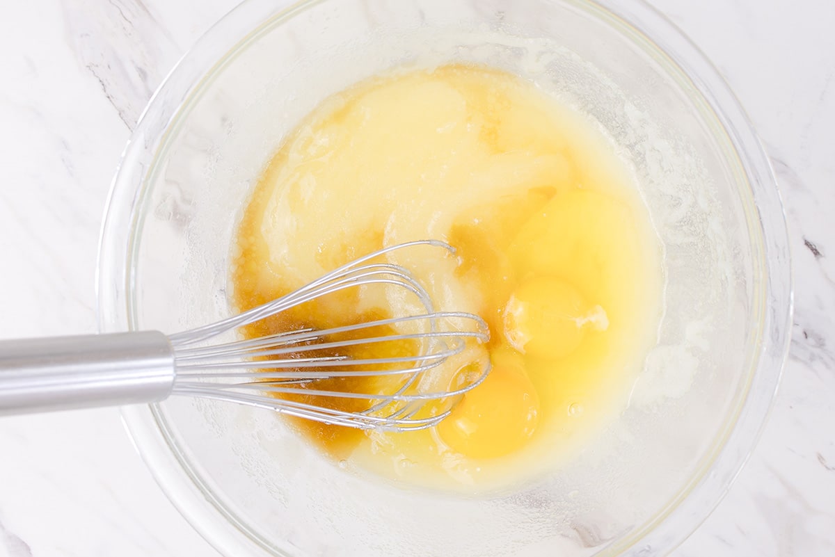 eggs and sugars whisked in a bowl