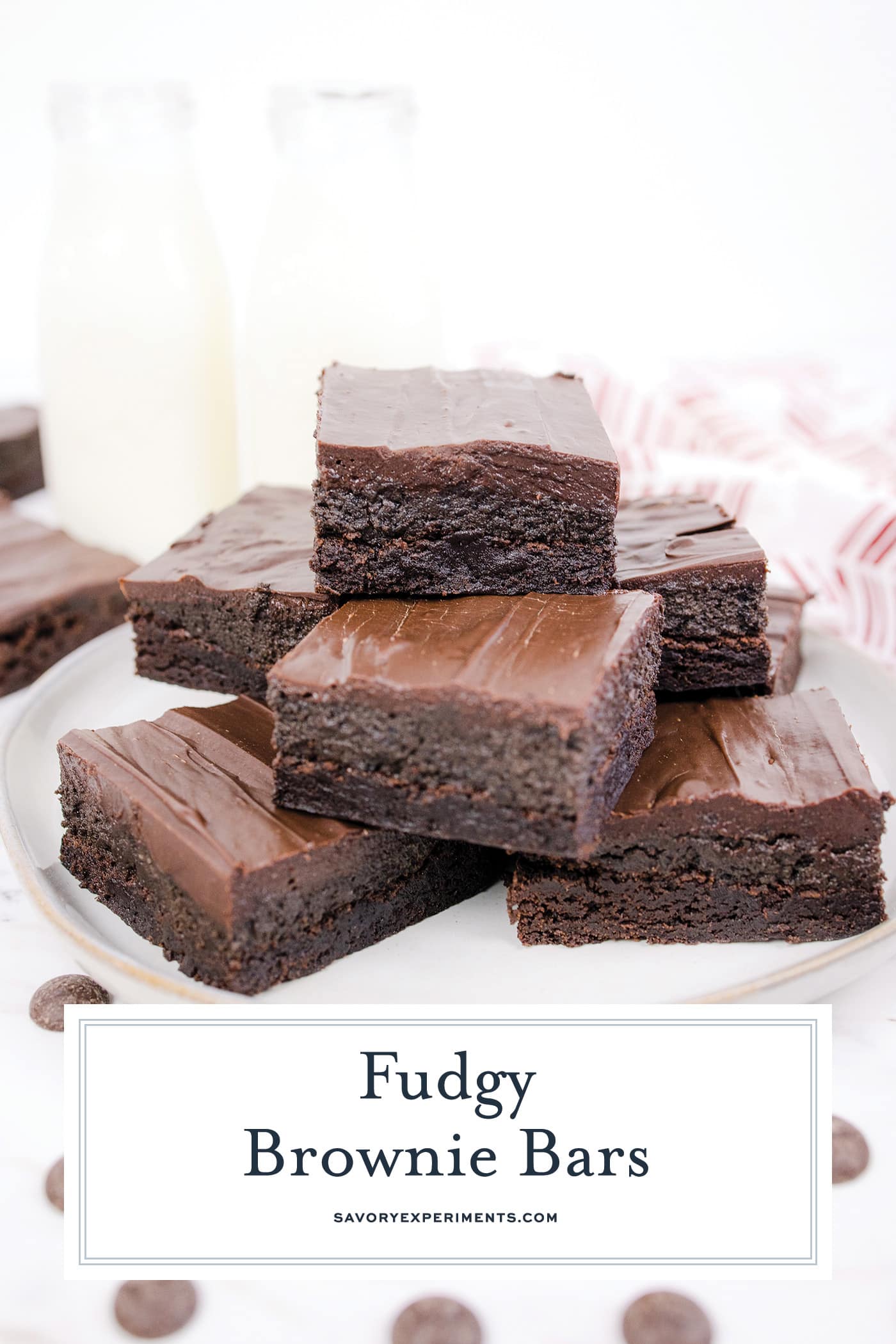 angled shot of plate of fudgy brownies with text overlay for pinterest
