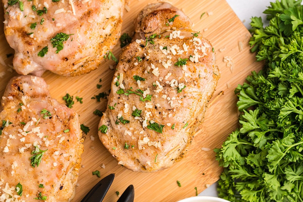 close up of grilled stuffed pork chop on cutting board