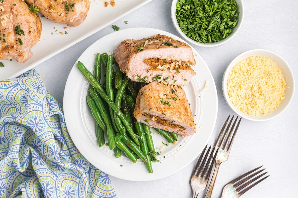 overhead shot of plate of grilled pork chops with green beans