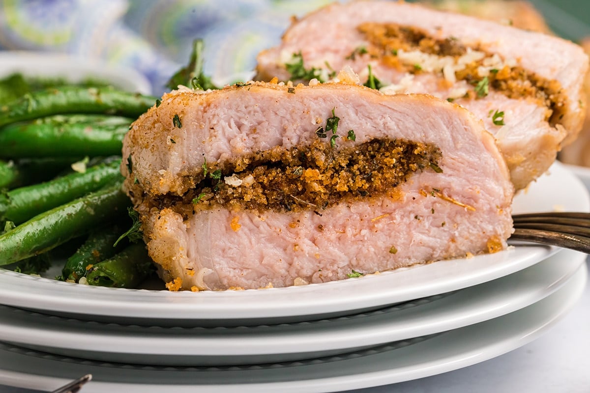 straight on close up shot of grilled stuffed pork chop cut in half