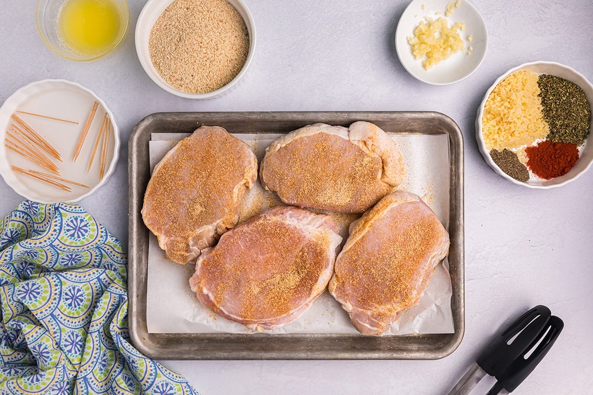 seasoned pork chops on a sheet pan