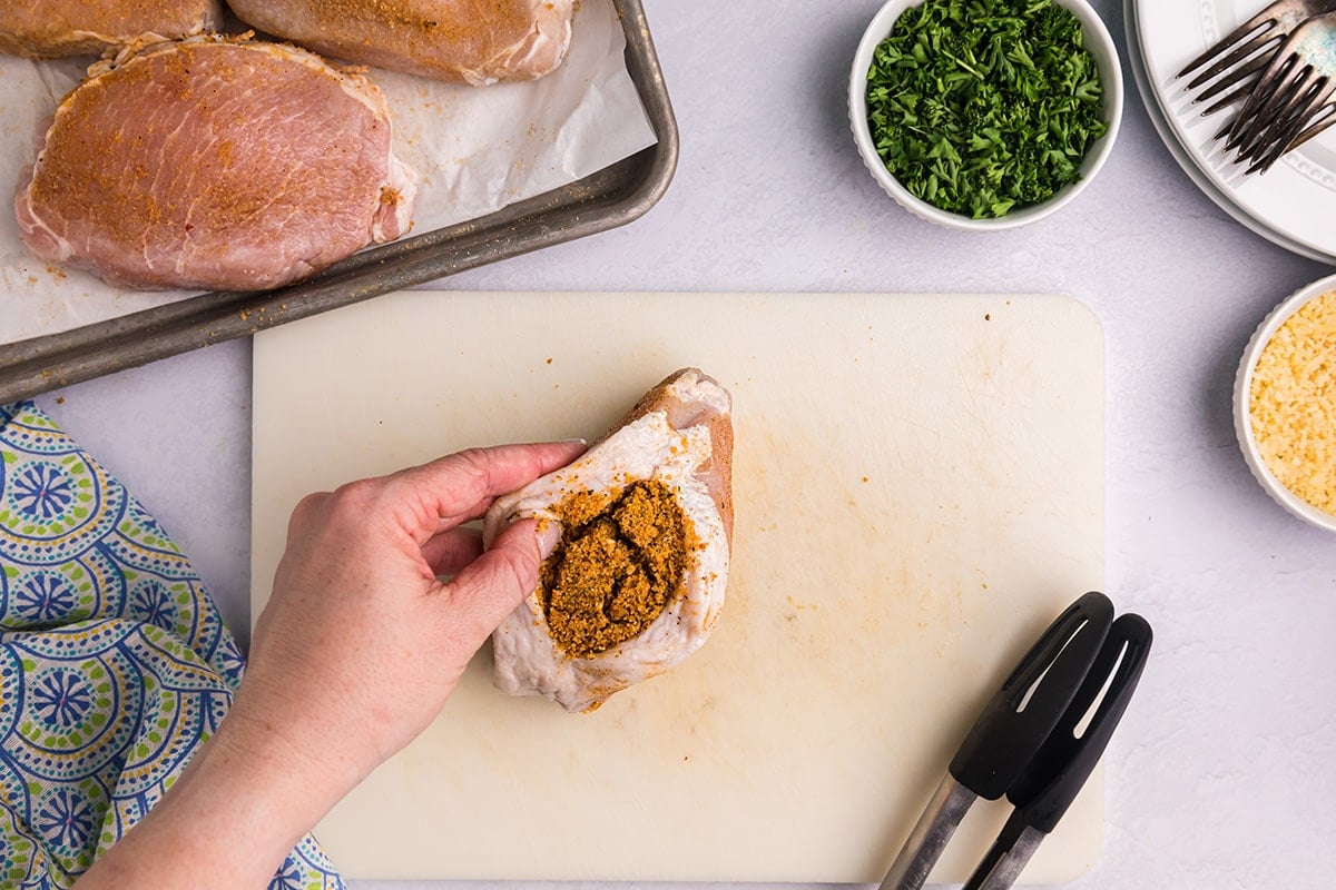 hand stuffing pork chop