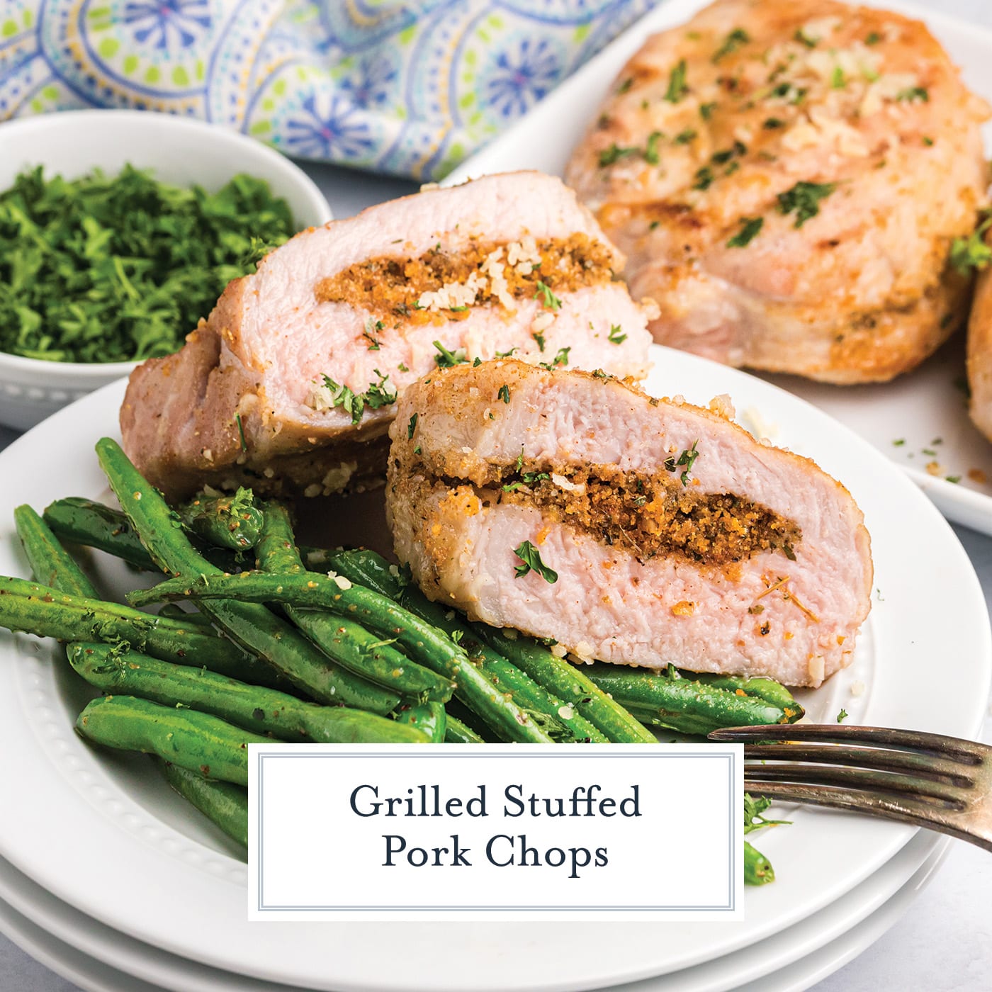 grilled stuffed pork chop cut in half with green beans with text overlay for facebook