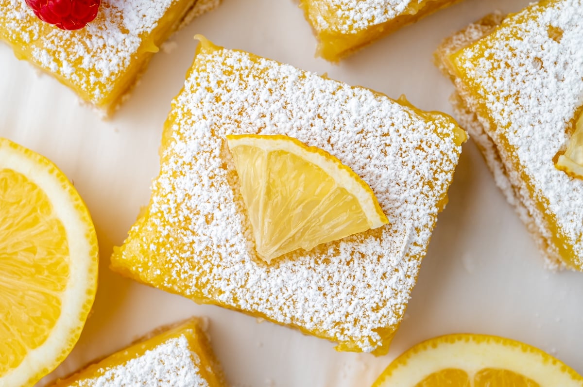 close up overhead shot of lemon bar topped with lemon