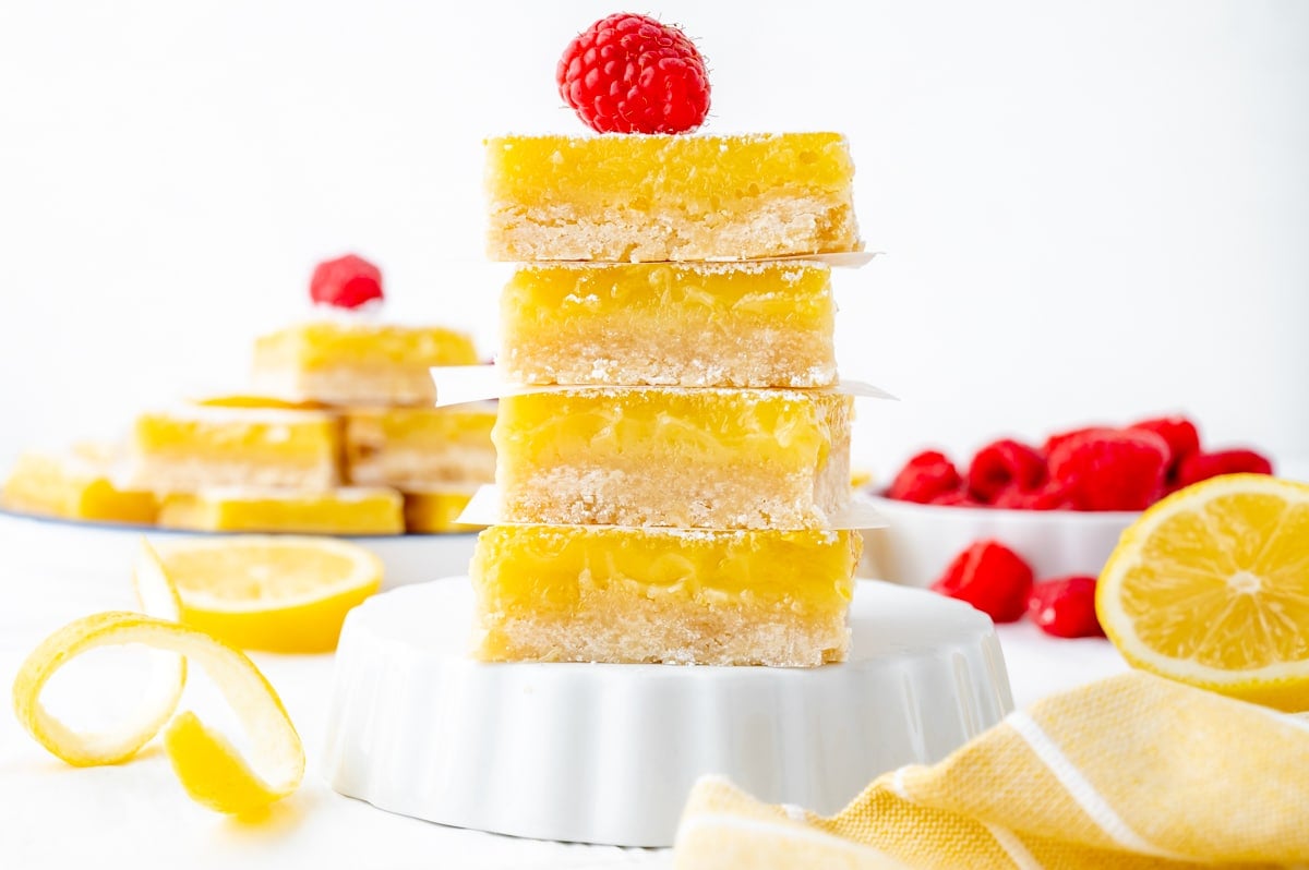 straight on shot of stack of lemon bars topped with raspberry