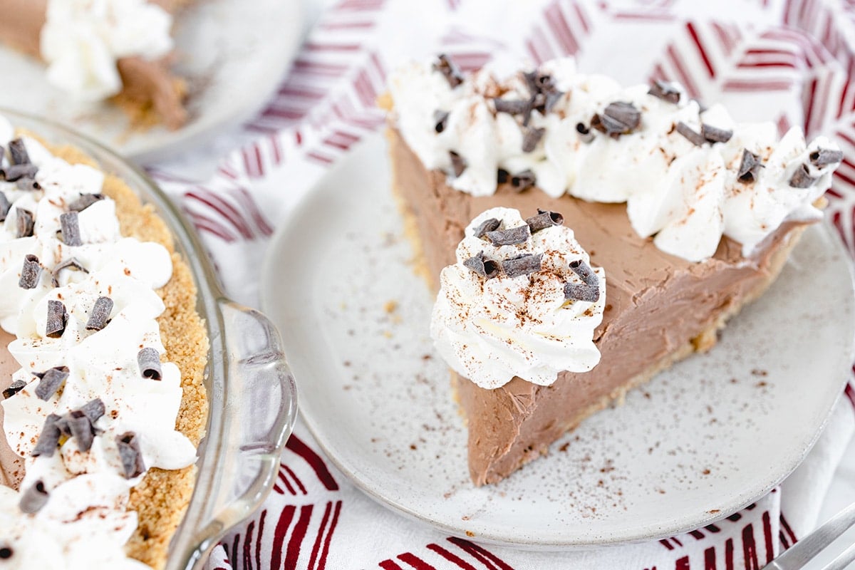 angled shot of slice of no bake chocolate cheesecake on plate