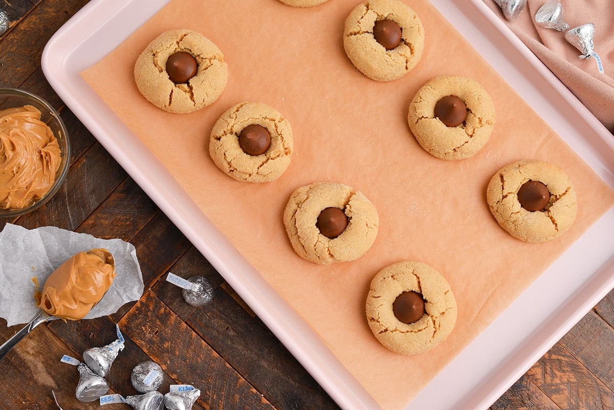 overhead shot of peanut butter blossoms on a cookie sheet