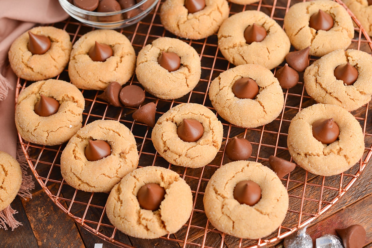 angled shot of peanut butter blossom cookies on a cooling rack