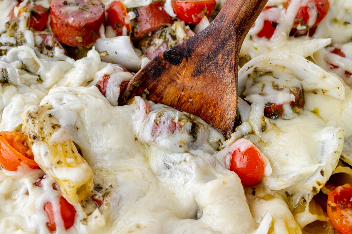 spoon digging into sausage pasta bake