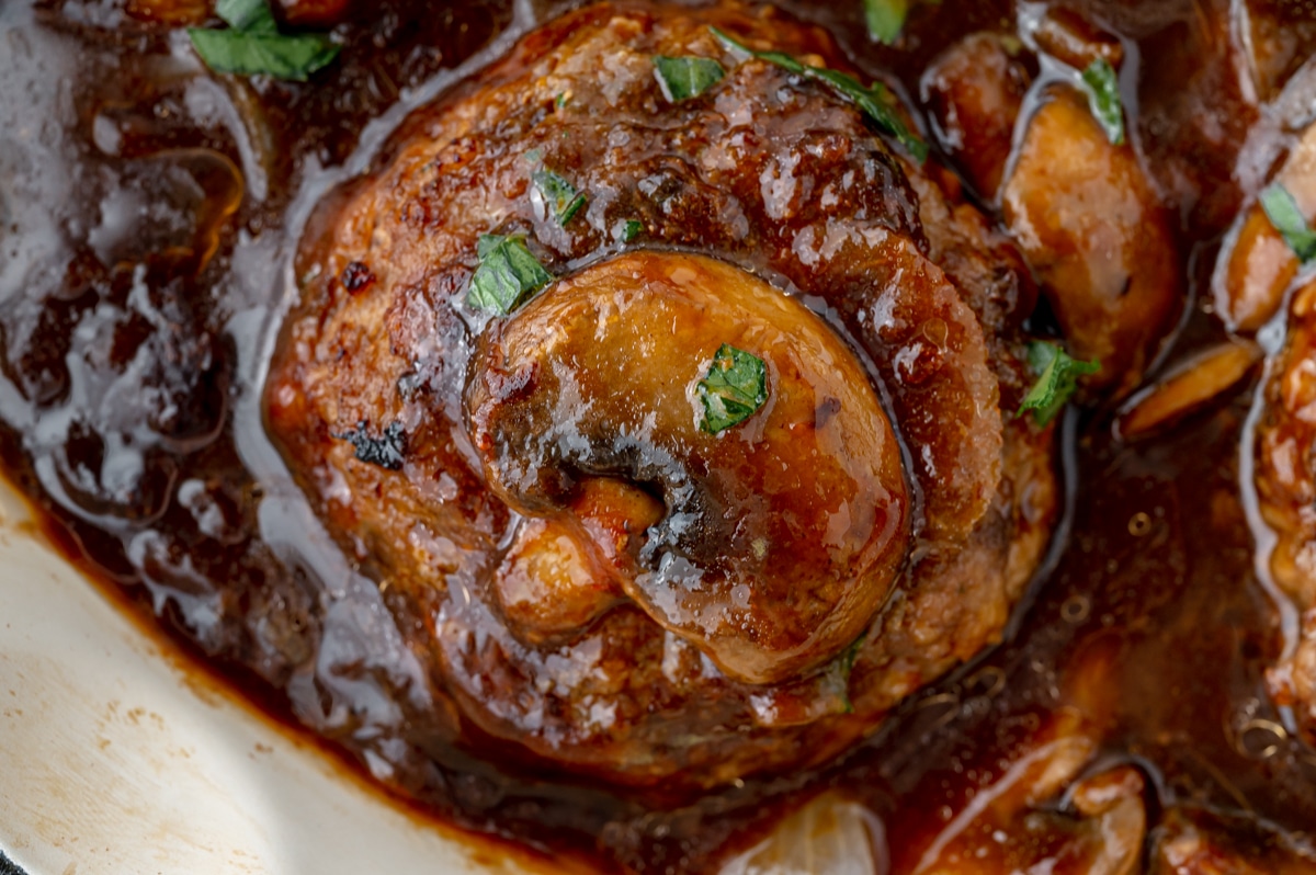 close up of salisbury steak in skillet