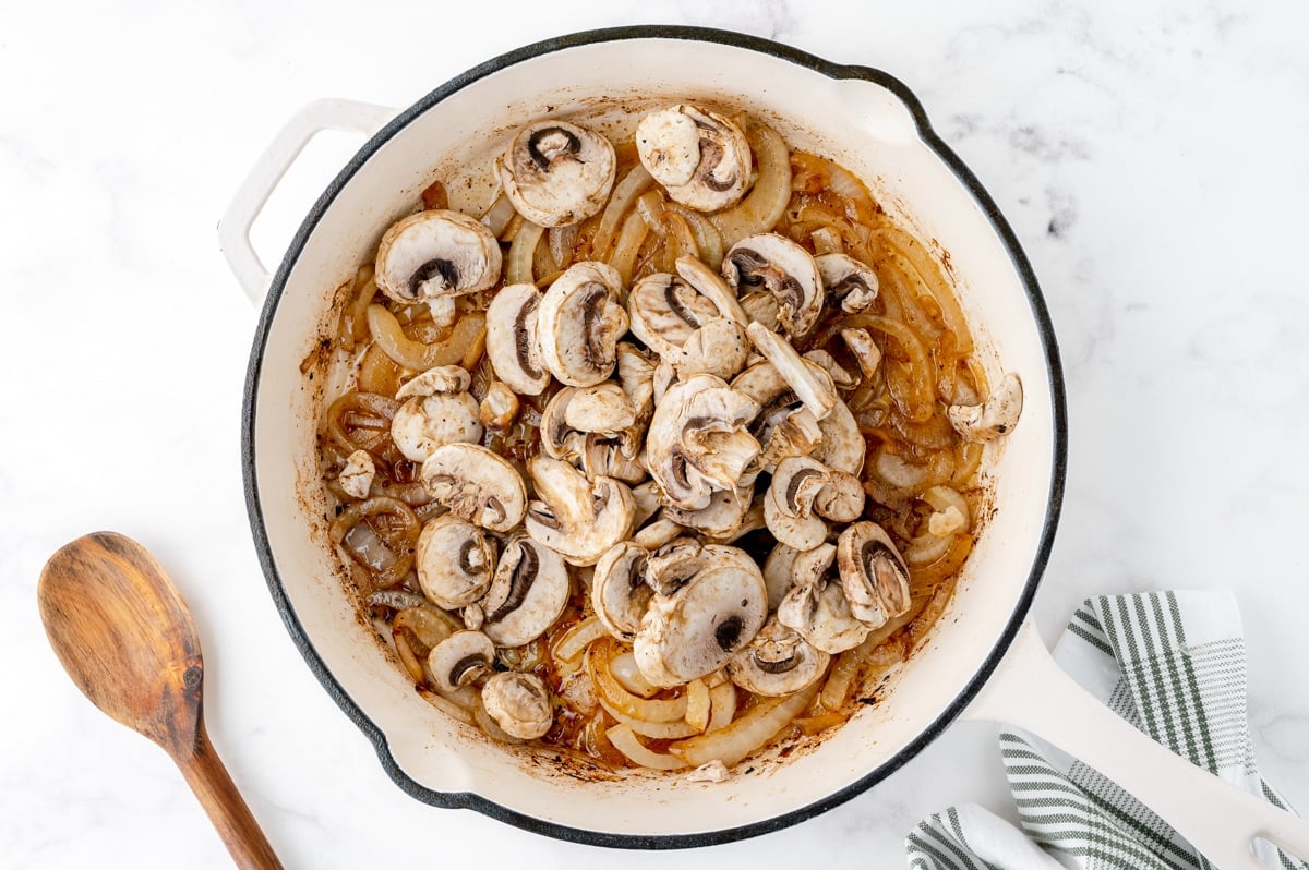 mushrooms and onions in a skillet