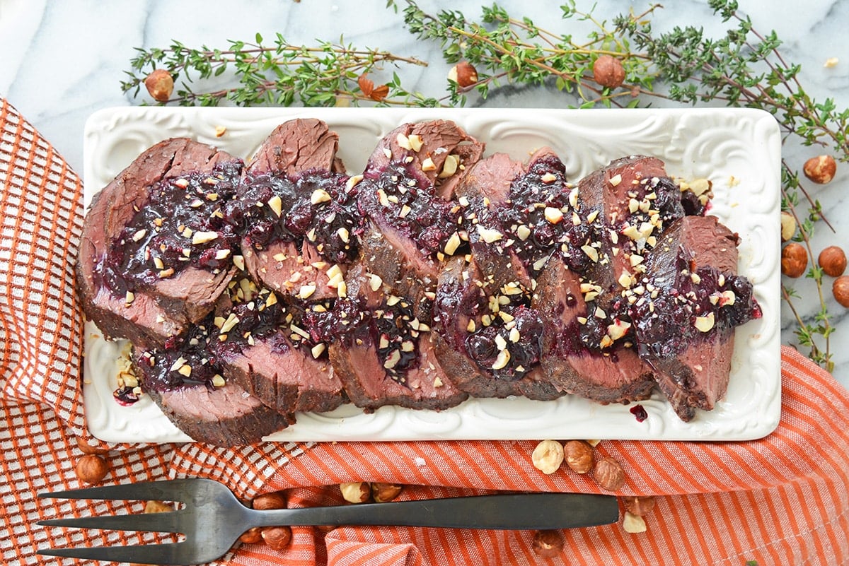 platter of beef with savory blueberry sauce and hazelnuts 