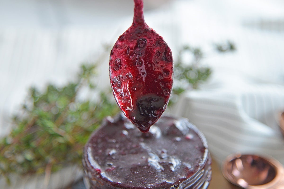 spoon dripping with blueberry sauce