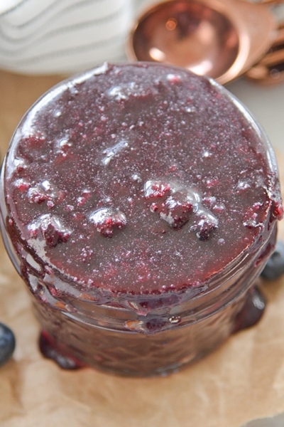 overhead of fruit sauce in a glass jar