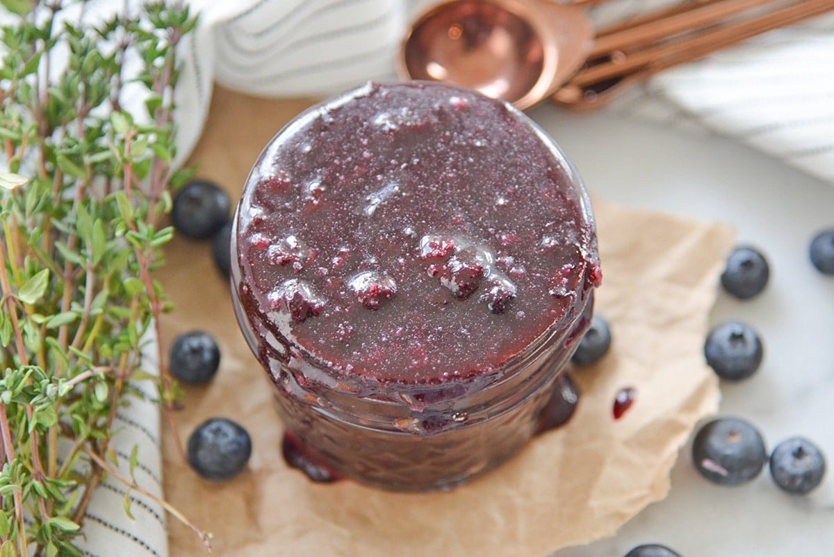 overhead of fruit sauce in a glass jar