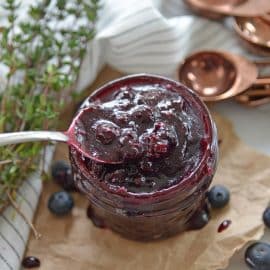 spoon dipping into fresh blueberry sauce