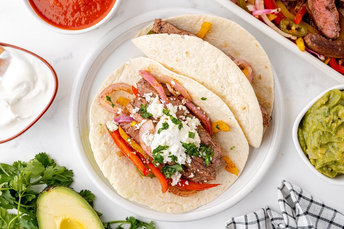 two steak fajitas on a plate