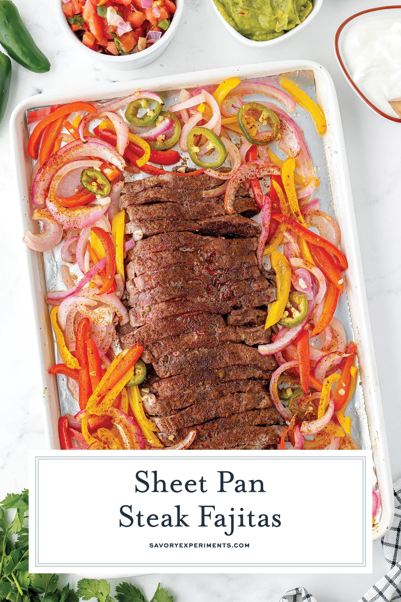 overhead shot of sheet pan steak fajitas with text overlay for pinterest