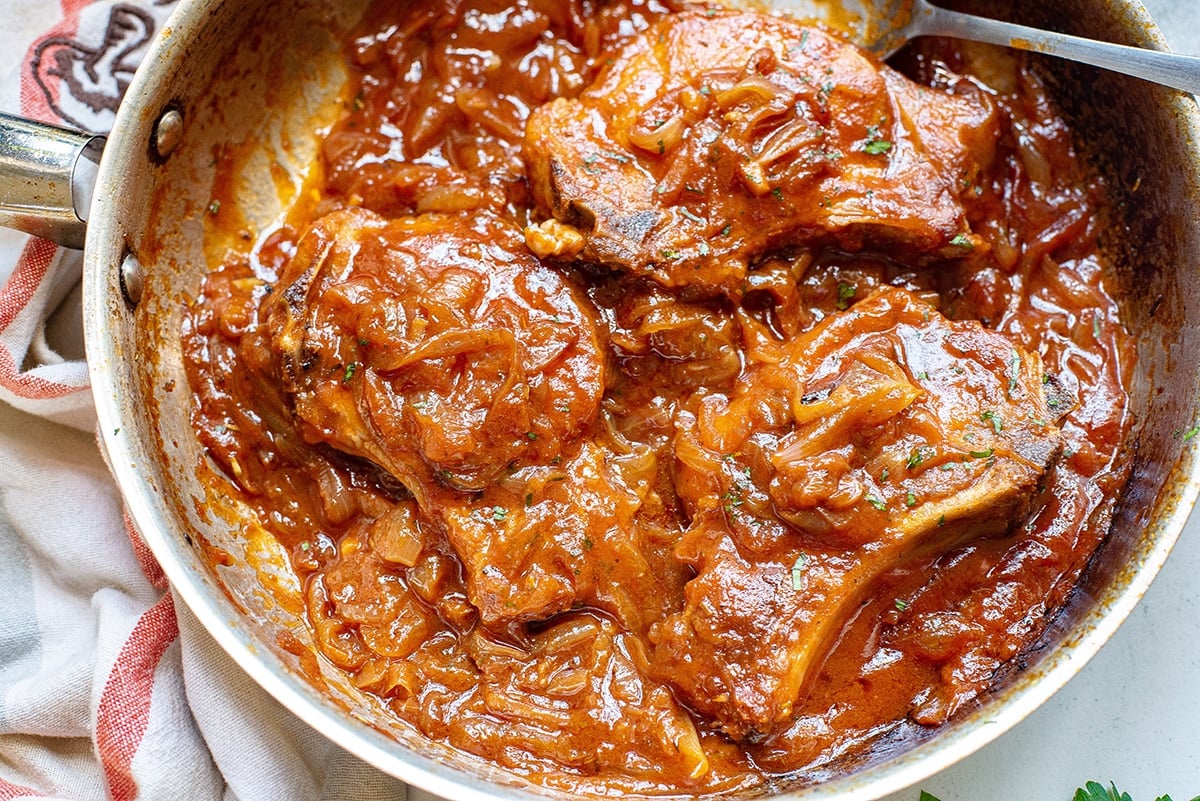 overhead shot of pan of smothered pork chops