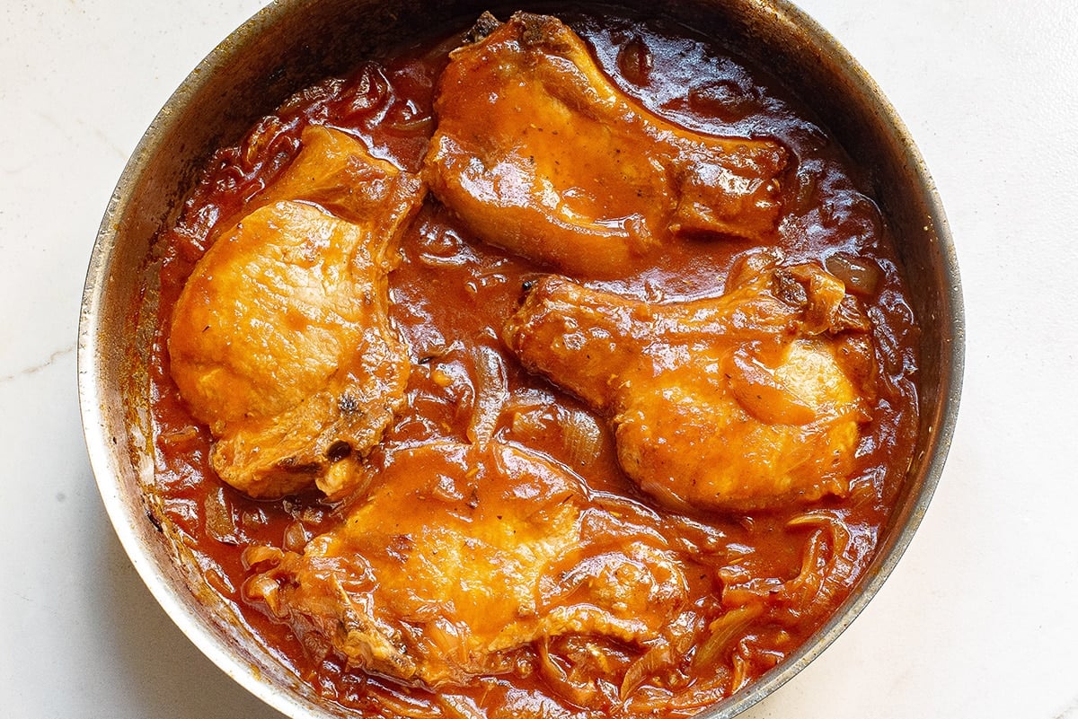 pork chops cooking in onion gravy