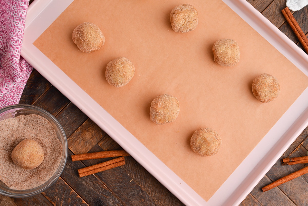 overhead shot of cookie dough balls on sheet pan