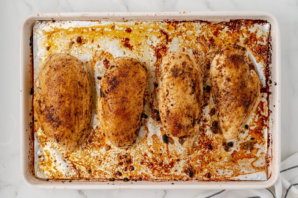overhead shot of baked chicken breasts on sheet pan