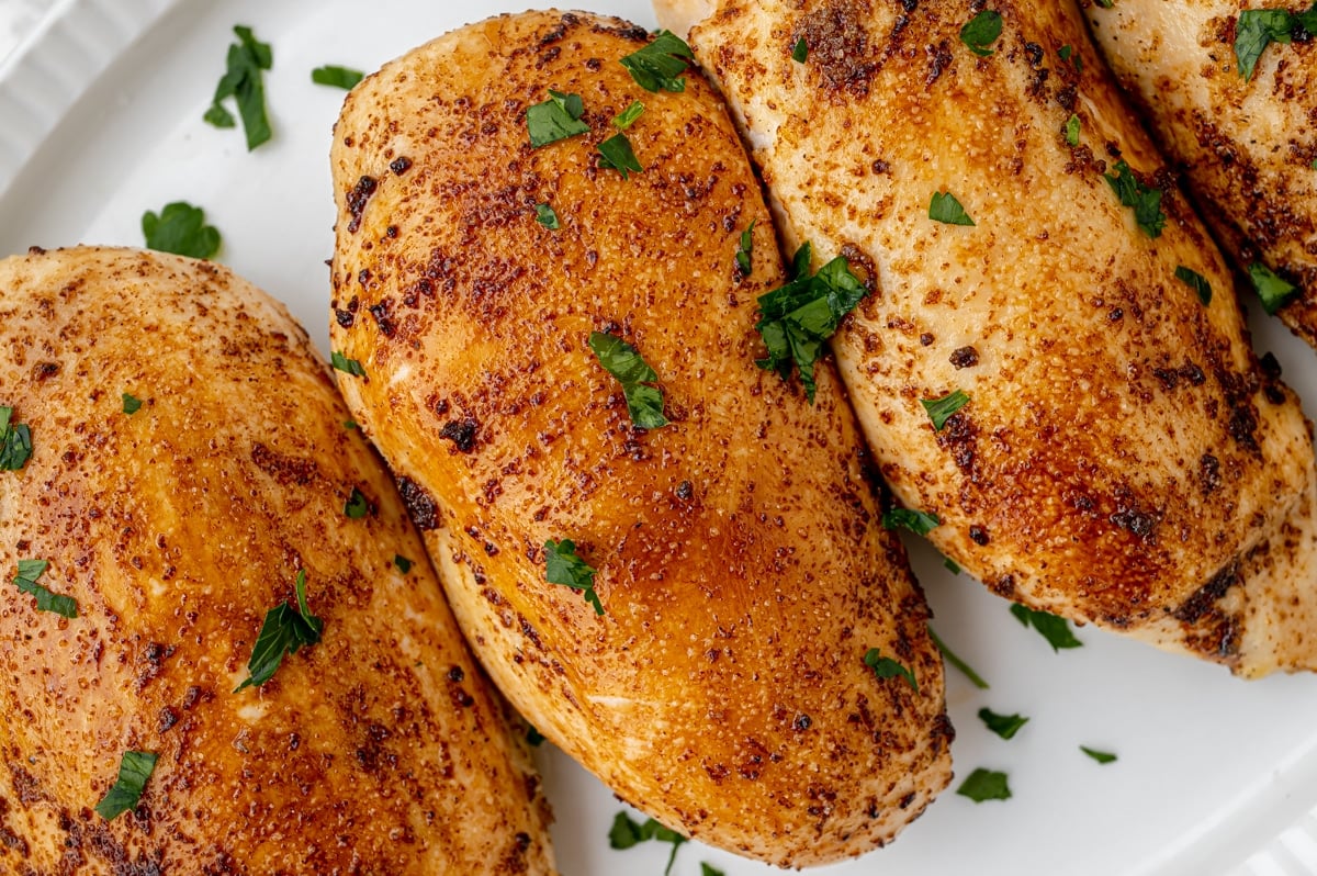 overhead shot of baked chicken breasts on a platter