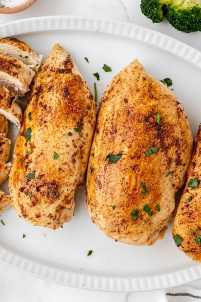 overhead shot of baked chicken breasts on a platter