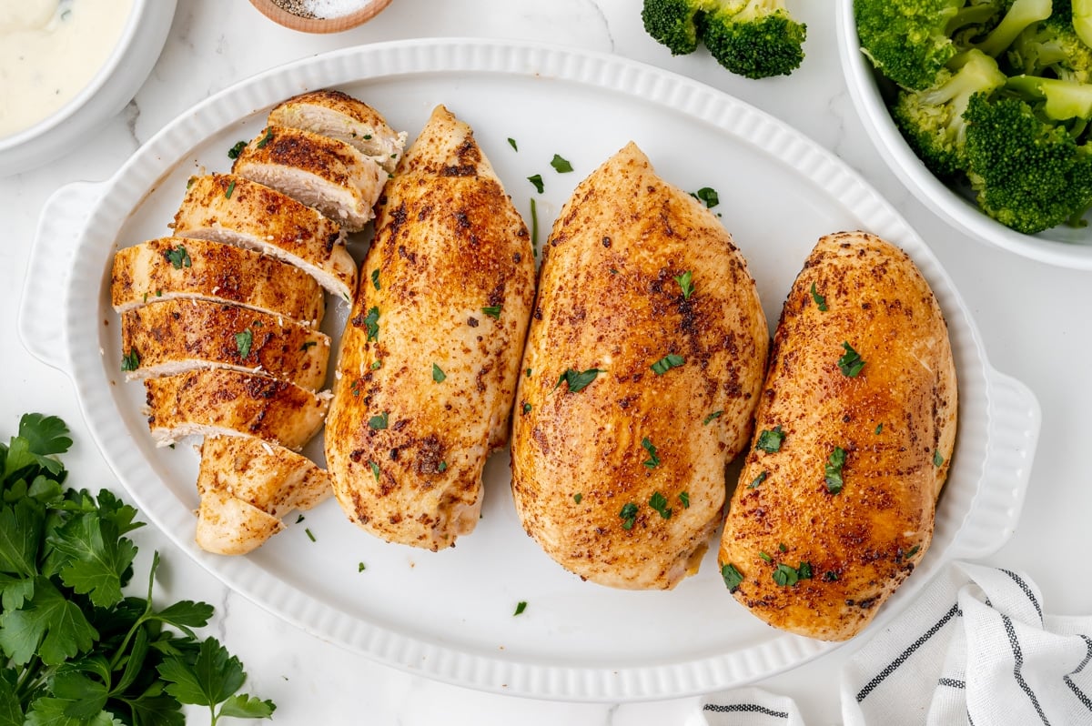 overhead shot of baked chicken breasts on a platter