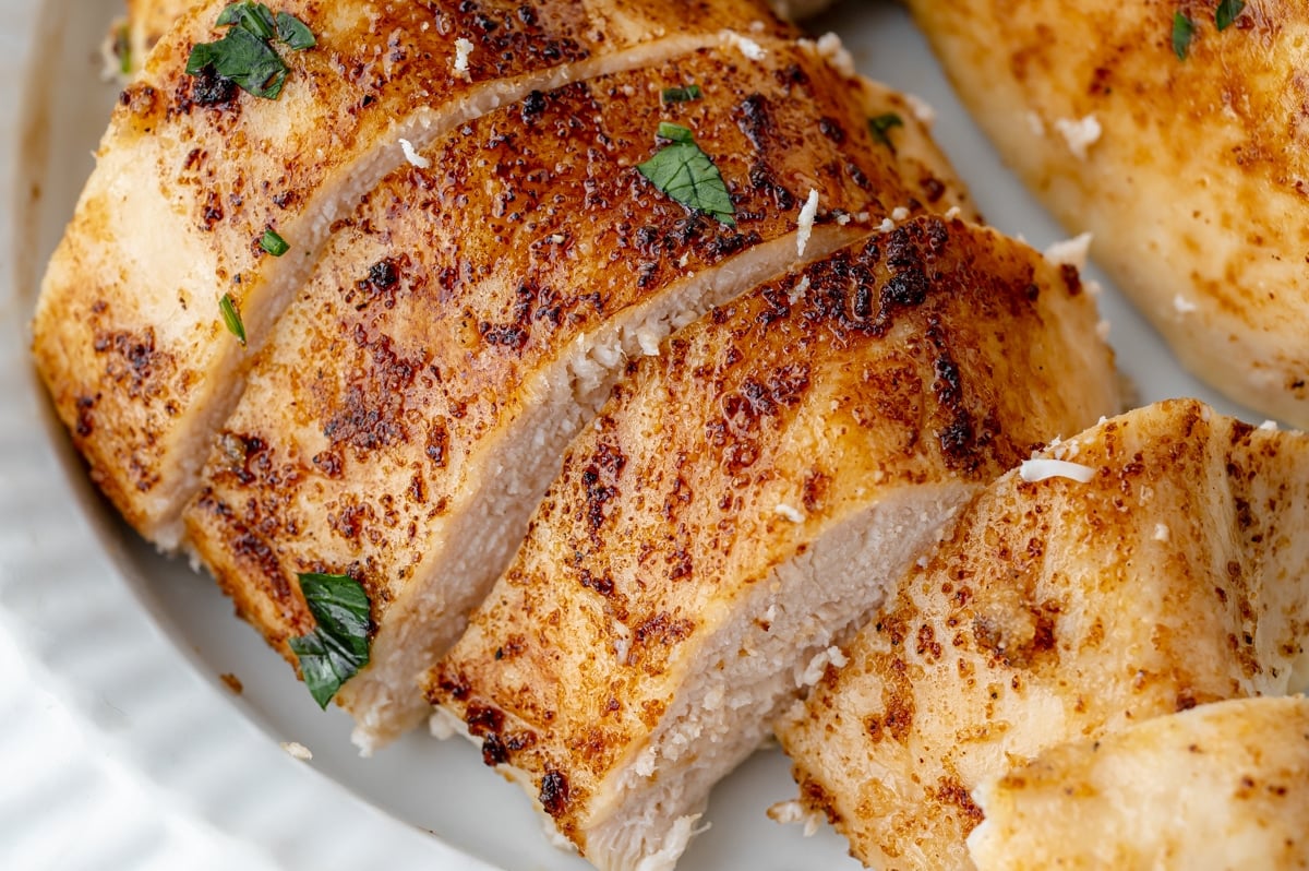 angled shot of sliced baked chicken breast